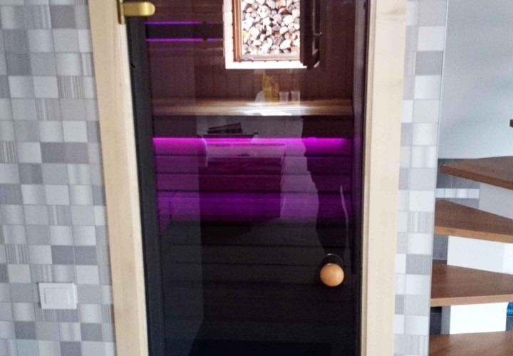 Sauna mit kontrastierender Innenausstattung und wärmespeicherndem Ofen